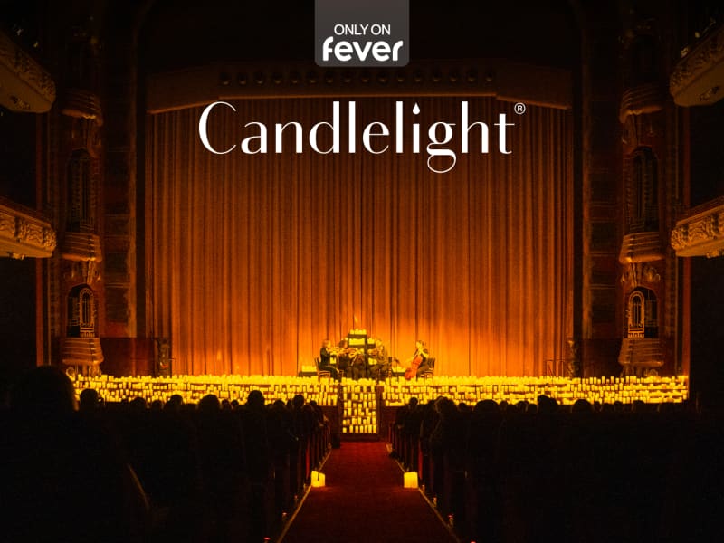 A theatre hall with hundreds of candles on the stage