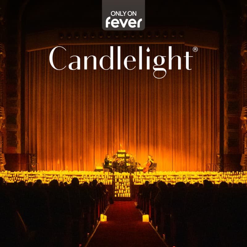 A theatre hall with hundreds of candles on the stage